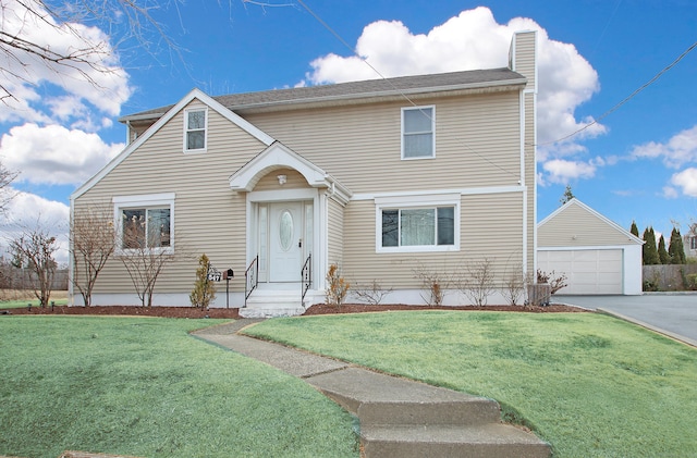 traditional home with a detached garage, a chimney, and a front yard