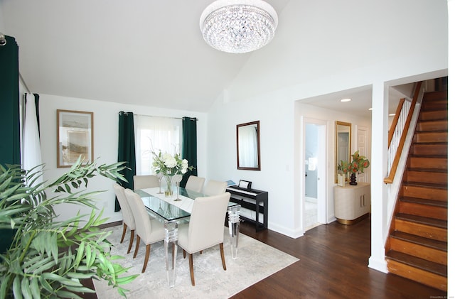 dining room with baseboards, dark wood-style flooring, stairs, vaulted ceiling, and a chandelier