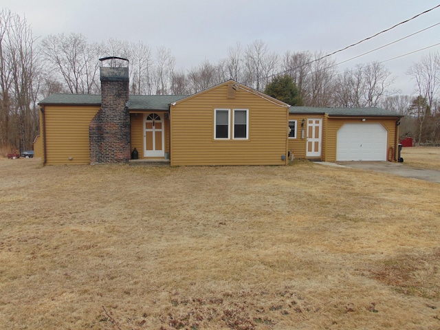 exterior space with a shingled roof, an attached garage, and a chimney