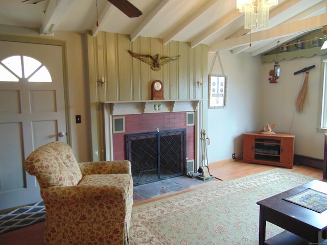 living room with wood finished floors, visible vents, beam ceiling, ceiling fan, and a brick fireplace