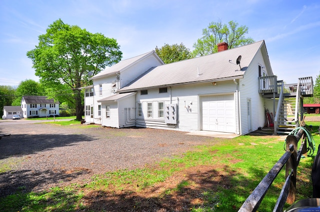 61 E St, Bethlehem, CT 06751 - rear view of house featuring a chimney, stairs, driveway, a deck, and a garage