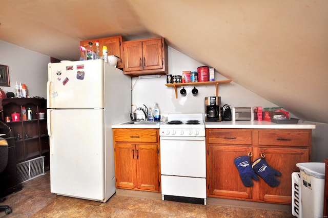 61 E St, Bethlehem, CT 06751 - kitchen featuring white appliances, vaulted ceiling, light countertops, a sink, and brown cabinets