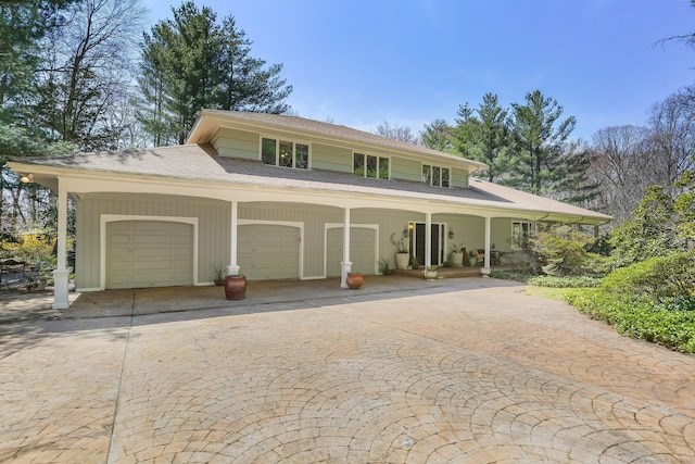 135 Wildwood Dr, Stratford, CT 06614 - view of front of home featuring an attached garage, driveway, and covered porch