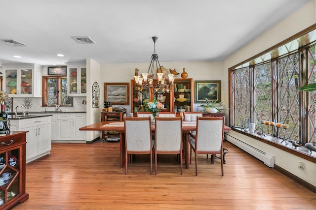 135 Wildwood Dr, Stratford, CT 06614 - dining area with a chandelier, light wood-type flooring, visible vents, and baseboard heating