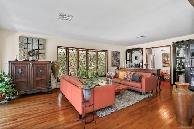 135 Wildwood Dr, Stratford, CT 06614 - living room featuring visible vents, wood finished floors, and a baseboard radiator