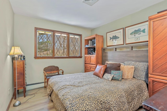 135 Wildwood Dr, Stratford, CT 06614 - bedroom featuring wood finished floors, visible vents, and baseboard heating