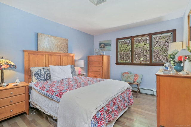 135 Wildwood Dr, Stratford, CT 06614 - bedroom featuring baseboard heating, wood finished floors, and visible vents