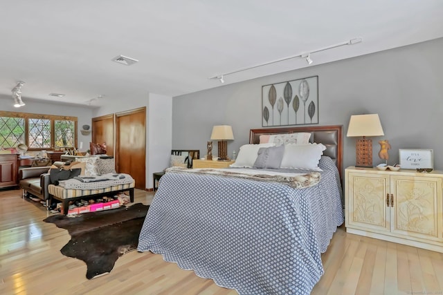 135 Wildwood Dr, Stratford, CT 06614 - bedroom featuring track lighting, visible vents, light wood finished floors, and a closet