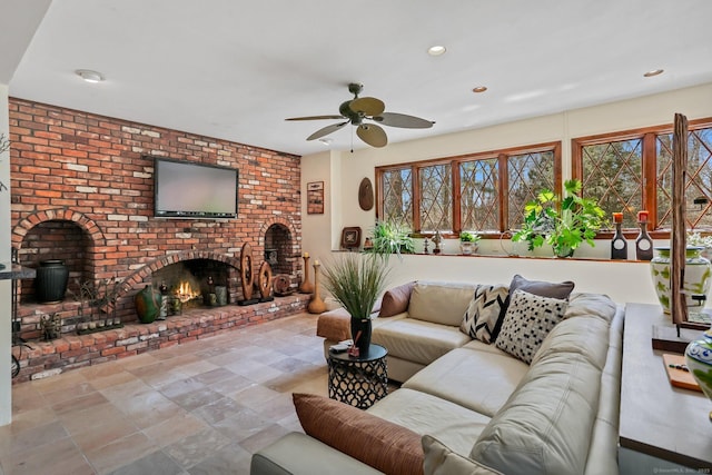 135 Wildwood Dr, Stratford, CT 06614 - living room with recessed lighting, plenty of natural light, a brick fireplace, and a ceiling fan