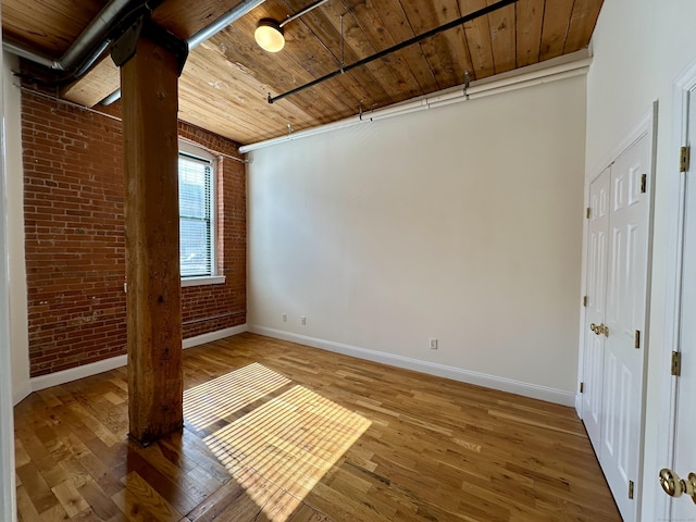 145 Canal St Unit 104, Shelton, CT 06484 - spare room with brick wall, hardwood / wood-style flooring, and wooden ceiling