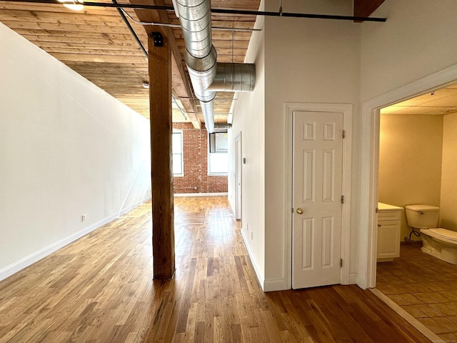 145 Canal St Unit 104, Shelton, CT 06484 - corridor with wood finished floors and brick wall