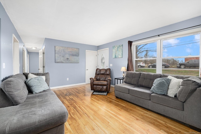 living room featuring wood finished floors and baseboards
