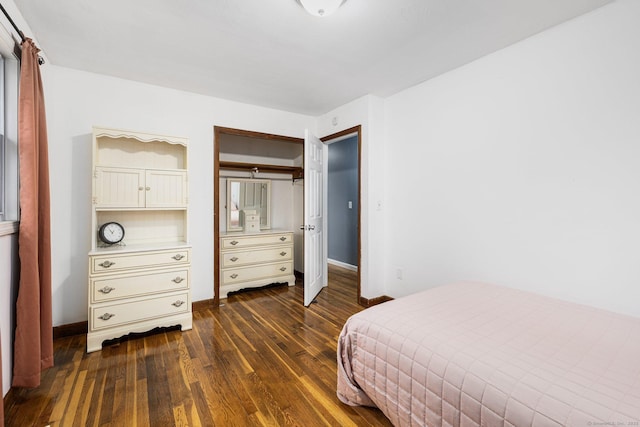bedroom with a closet, dark wood-style floors, and baseboards
