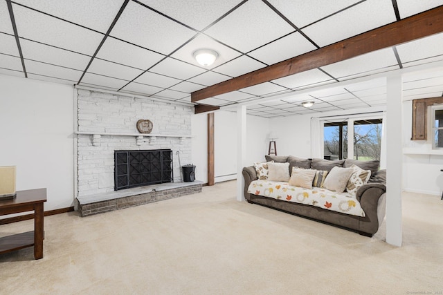 carpeted living room featuring a fireplace, a paneled ceiling, a baseboard radiator, and baseboards