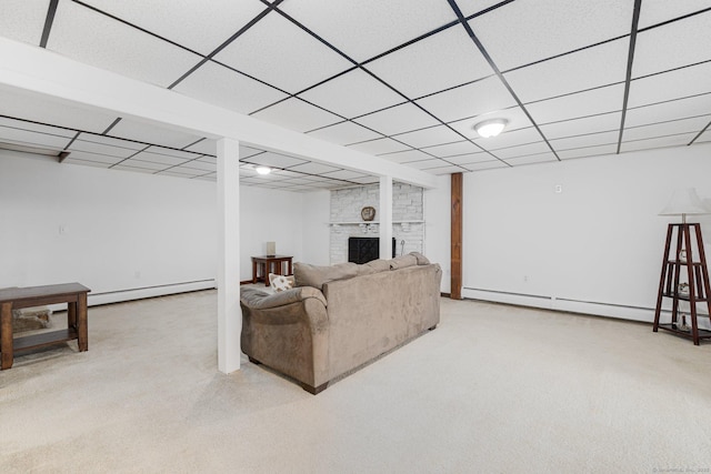 living room with carpet, a drop ceiling, a baseboard heating unit, a brick fireplace, and a baseboard radiator