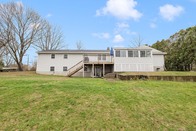 rear view of house with a yard, stairway, and a deck