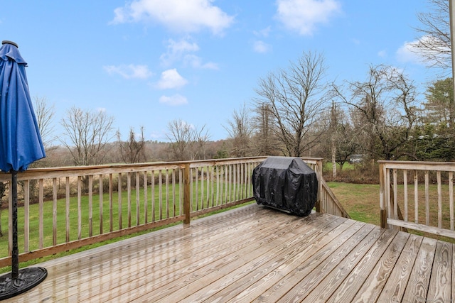 deck with grilling area and a lawn