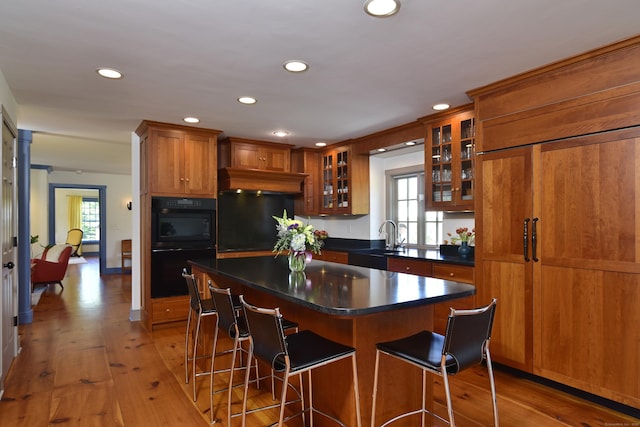 40 Shields Rd, Woodstock, CT 06281 - kitchen featuring a sink, brown cabinets, recessed lighting, light wood-style floors, and a breakfast bar area