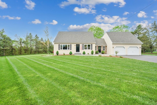 new england style home featuring asphalt driveway, a front lawn, and a garage