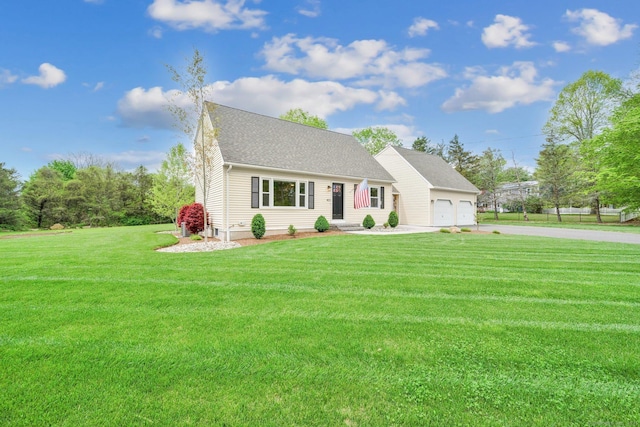 view of front of property featuring concrete driveway, a garage, a front lawn, and roof with shingles