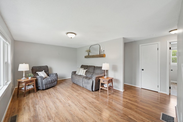 living area featuring wood finished floors and baseboards