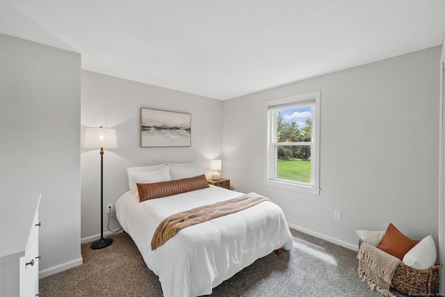 bedroom featuring carpet and baseboards