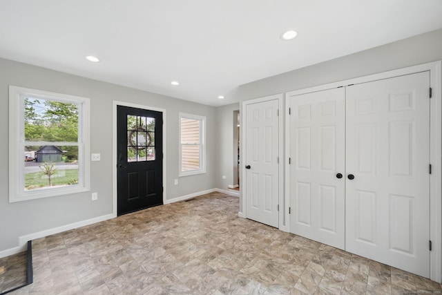 foyer featuring baseboards and recessed lighting