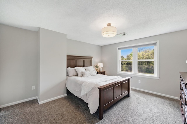 bedroom with baseboards, light colored carpet, and a textured ceiling