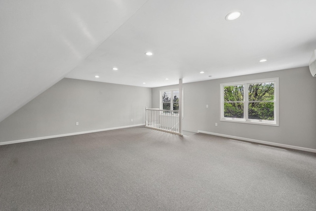 unfurnished room with recessed lighting, baseboards, carpet flooring, and vaulted ceiling