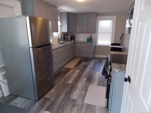 kitchen featuring a healthy amount of sunlight, appliances with stainless steel finishes, and gray cabinetry