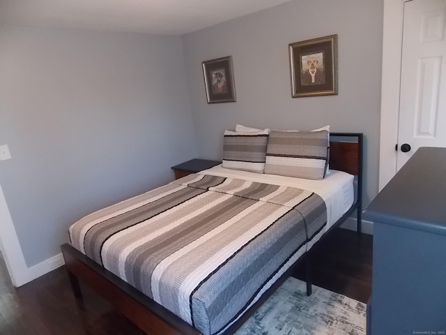 bedroom featuring wood finished floors and baseboards