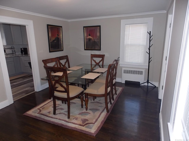 dining space featuring crown molding, baseboards, radiator heating unit, and dark wood-type flooring