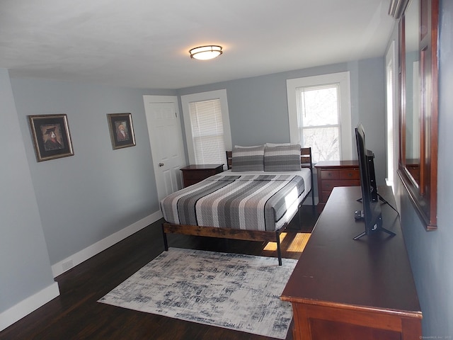 bedroom featuring baseboards and wood finished floors