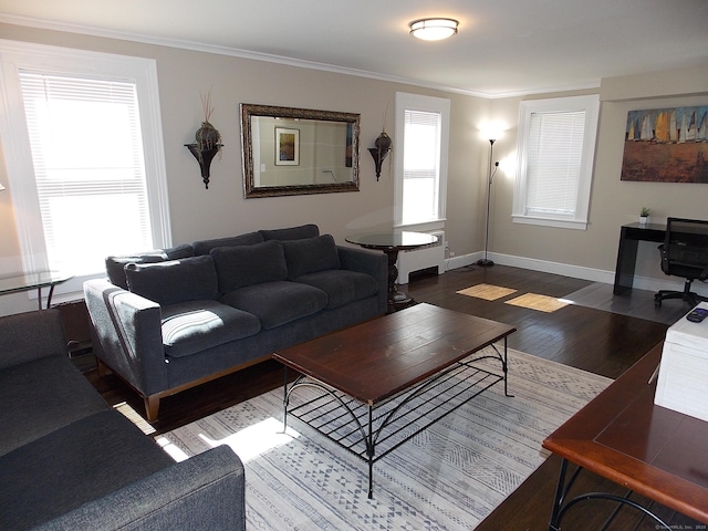 living area with crown molding, wood finished floors, and baseboards