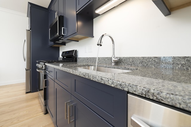 25 Oakwood Cir Unit 7, Plainville, CT 06062 - kitchen featuring light wood-style floors, baseboards, a sink, stone counters, and appliances with stainless steel finishes