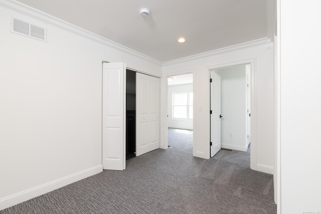 25 Oakwood Cir Unit 7, Plainville, CT 06062 - unfurnished bedroom featuring baseboards, ornamental molding, dark carpet, and visible vents