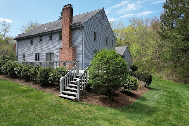 32 Woodmont Rd, Avon, CT 06001 - rear view of property with a chimney, a wooden deck, and a lawn