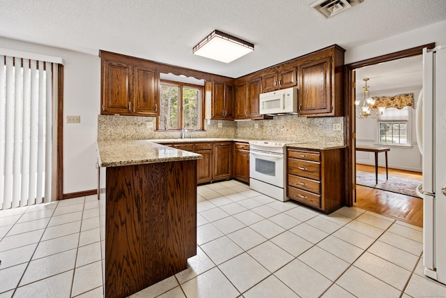 32 Woodmont Rd, Avon, CT 06001 - kitchen with white appliances, decorative backsplash, plenty of natural light, and a textured ceiling