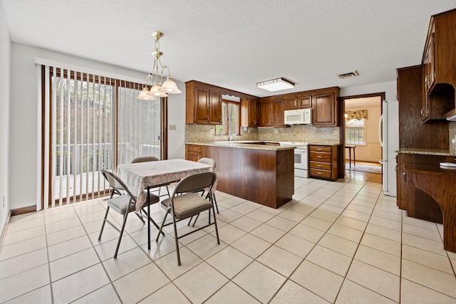 32 Woodmont Rd, Avon, CT 06001 - kitchen featuring white appliances, decorative backsplash, plenty of natural light, a peninsula, and a textured ceiling