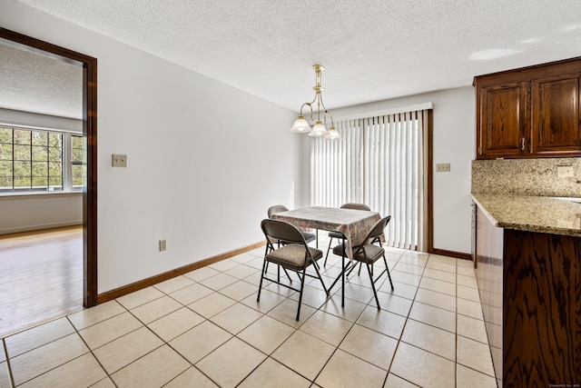 32 Woodmont Rd, Avon, CT 06001 - dining room with a textured ceiling, a chandelier, baseboards, and light tile patterned flooring