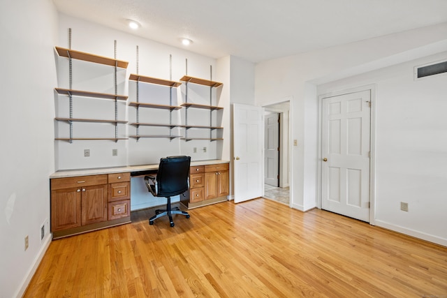 32 Woodmont Rd, Avon, CT 06001 - office area with light wood finished floors, built in desk, and baseboards