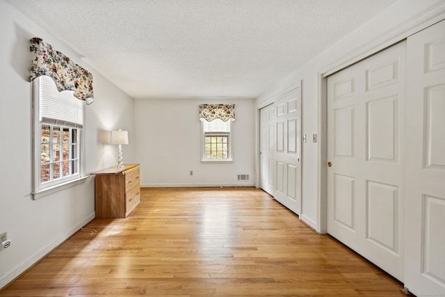 32 Woodmont Rd, Avon, CT 06001 - unfurnished bedroom with a textured ceiling, light wood-style floors, and baseboards