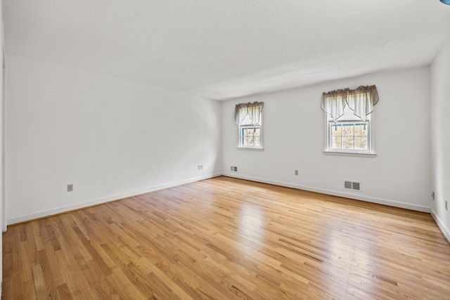 32 Woodmont Rd, Avon, CT 06001 - spare room featuring light wood finished floors, baseboards, and a textured ceiling
