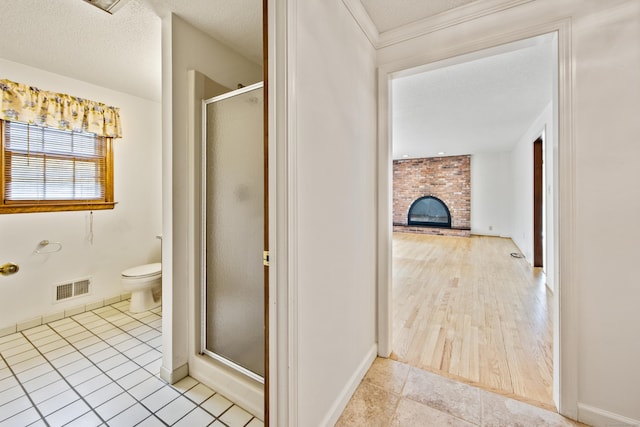 32 Woodmont Rd, Avon, CT 06001 - bathroom with a shower stall, tile patterned flooring, a brick fireplace, toilet, and baseboards