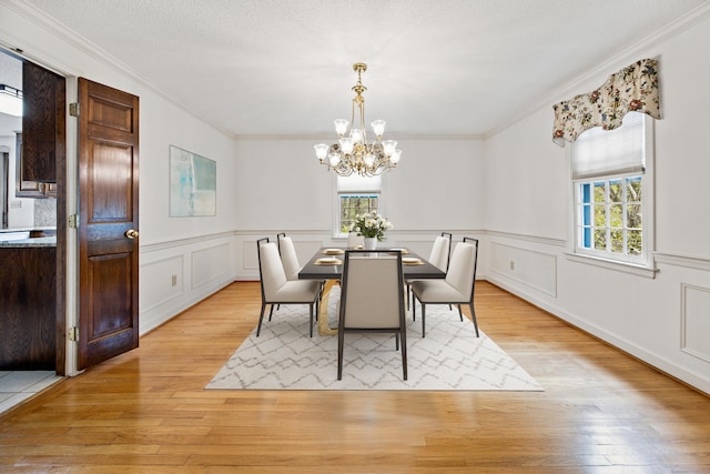 32 Woodmont Rd, Avon, CT 06001 - dining space featuring a chandelier, ornamental molding, light wood-type flooring, and a wainscoted wall