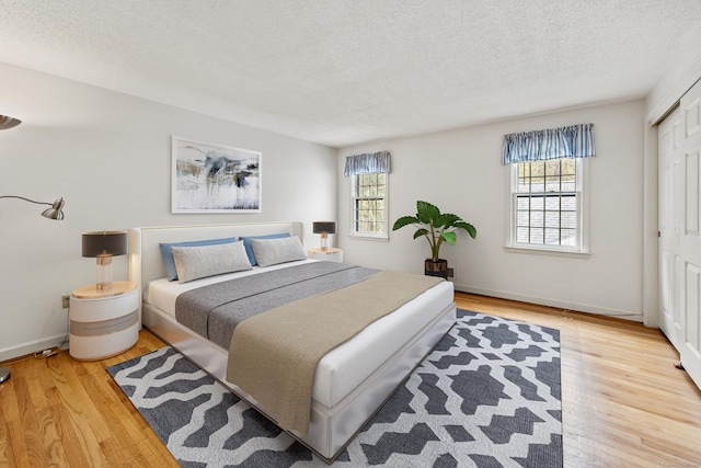 32 Woodmont Rd, Avon, CT 06001 - bedroom featuring multiple windows, wood finished floors, a textured ceiling, and a closet