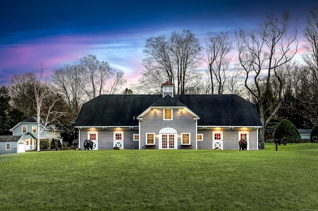 view of front of property featuring a yard and french doors