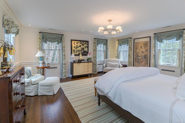 bedroom featuring a chandelier, crown molding, and wood finished floors