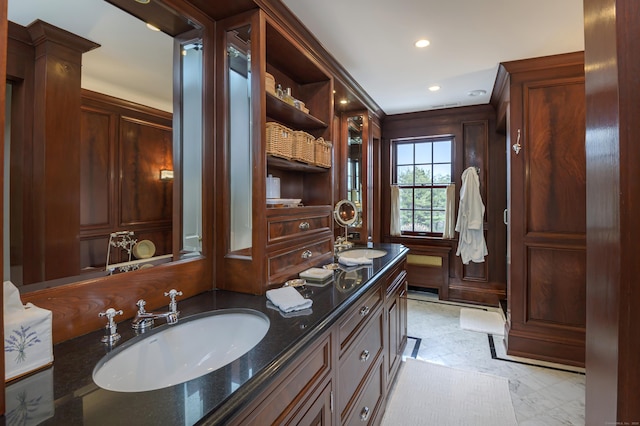 bathroom with a sink, double vanity, and recessed lighting