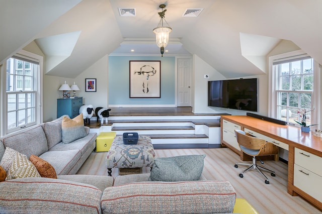 office featuring visible vents, lofted ceiling, and a healthy amount of sunlight